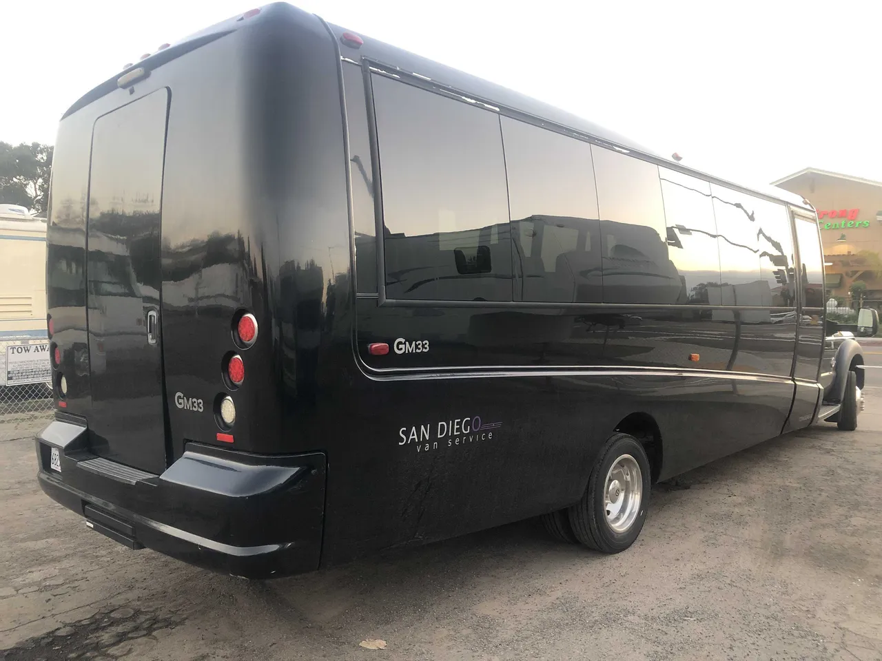 Black 21 Passenger Mini Coach exterior with tinted windows for minibus rental