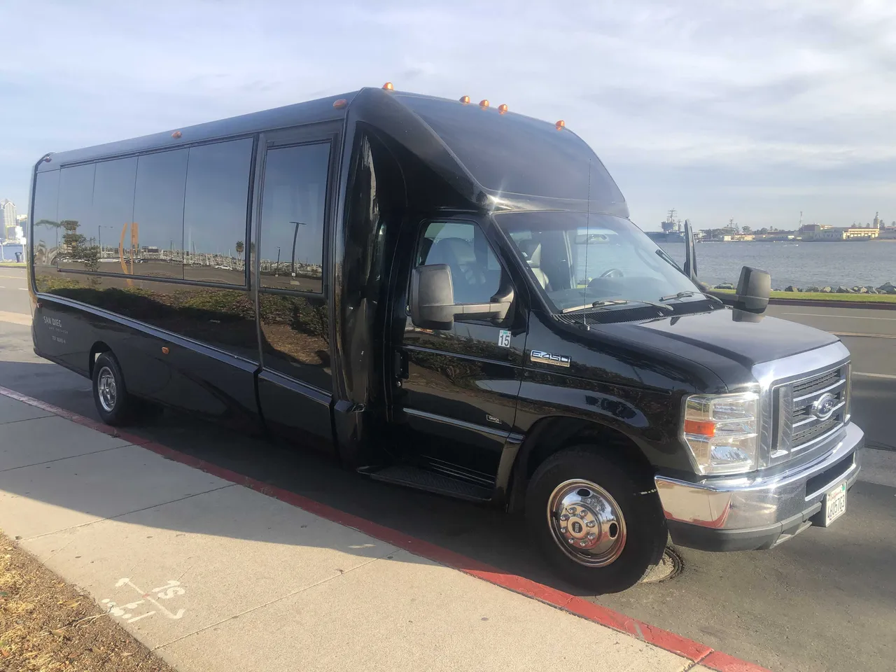 Black 21 Passenger Mini Coach exterior with tinted windows, photo 3 for minibus rental
