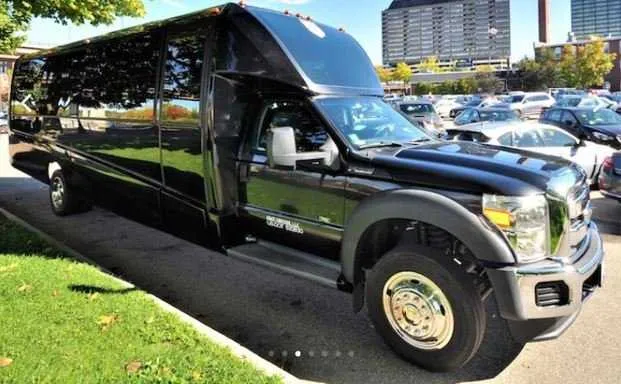 Mini Coach Limousine Bus in black, tinted windows