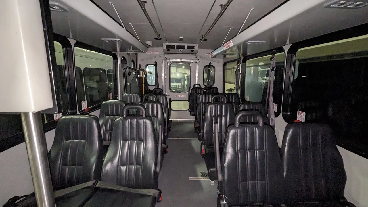 Mini Moto Coach interior with grab handles and rails for minibus rental