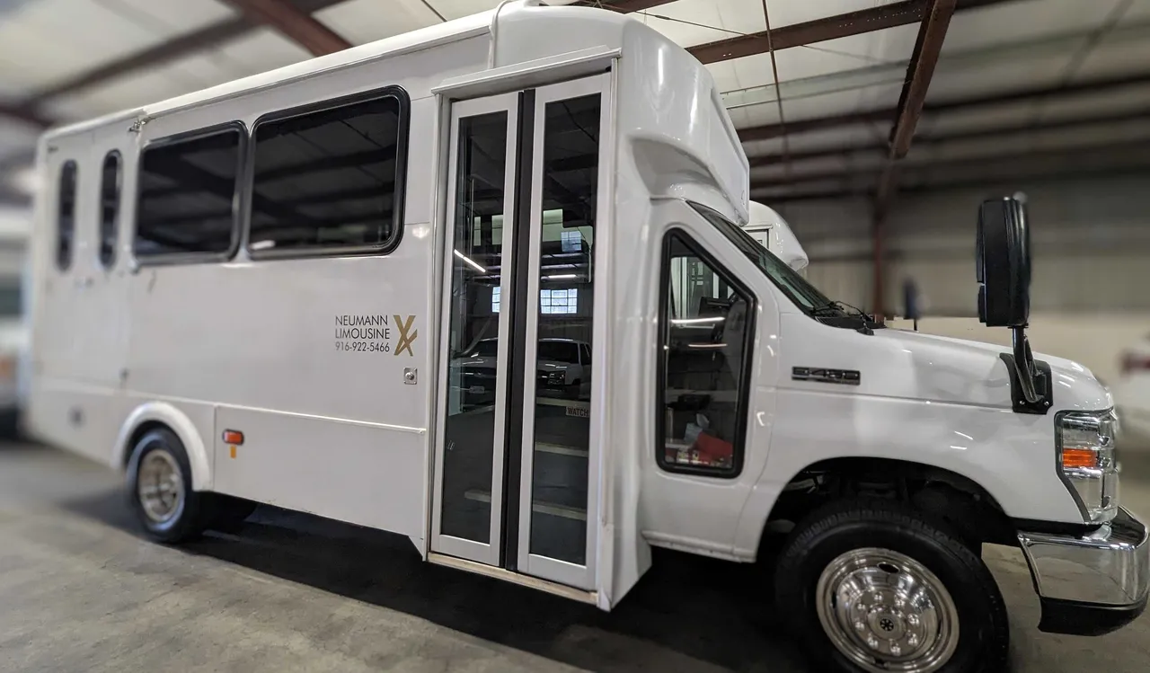 White Mini Moto Coach with tinted windows for minibus rental