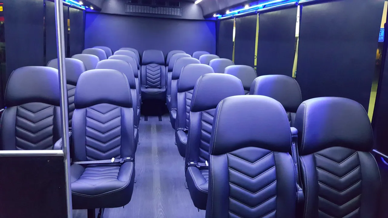 23 Passenger Mini Coach interior with window shades and LED accent lighting for minibus rental