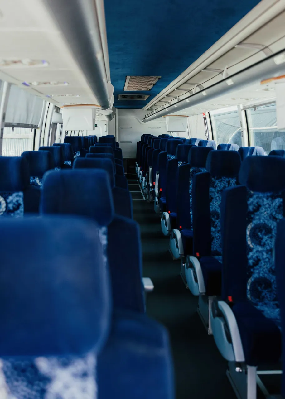 56 Passenger Motor Coach interior with overhead parcel racks, photo 5 for charter bus rental