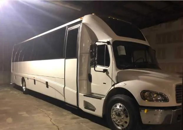 White Freightliner Executive Mini Coach with tinted windows for minibus rental