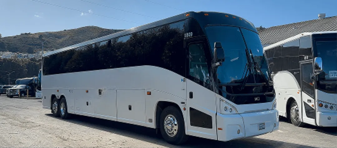40 Passenger Motorcoach White 40 Passenger Motorcoach with tinted windows for charter bus rental