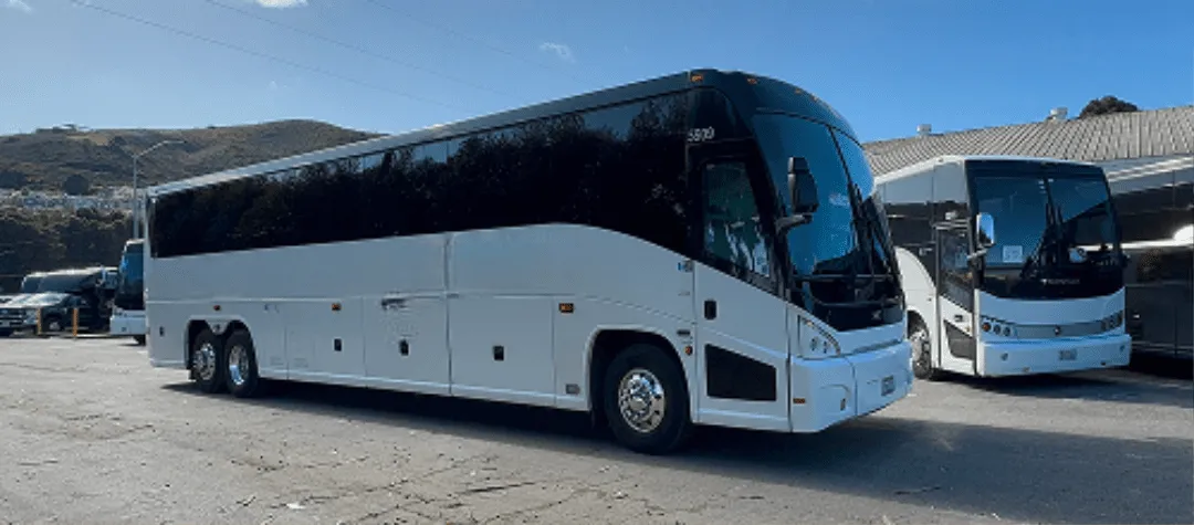 White 56 Passenger Motorcoach with tinted windows for charter bus rental