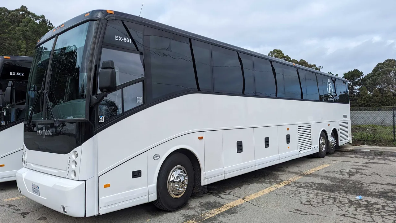 56 Passenger Motorcoach White 56 Passenger Motorcoach with tinted windows for charter bus rental