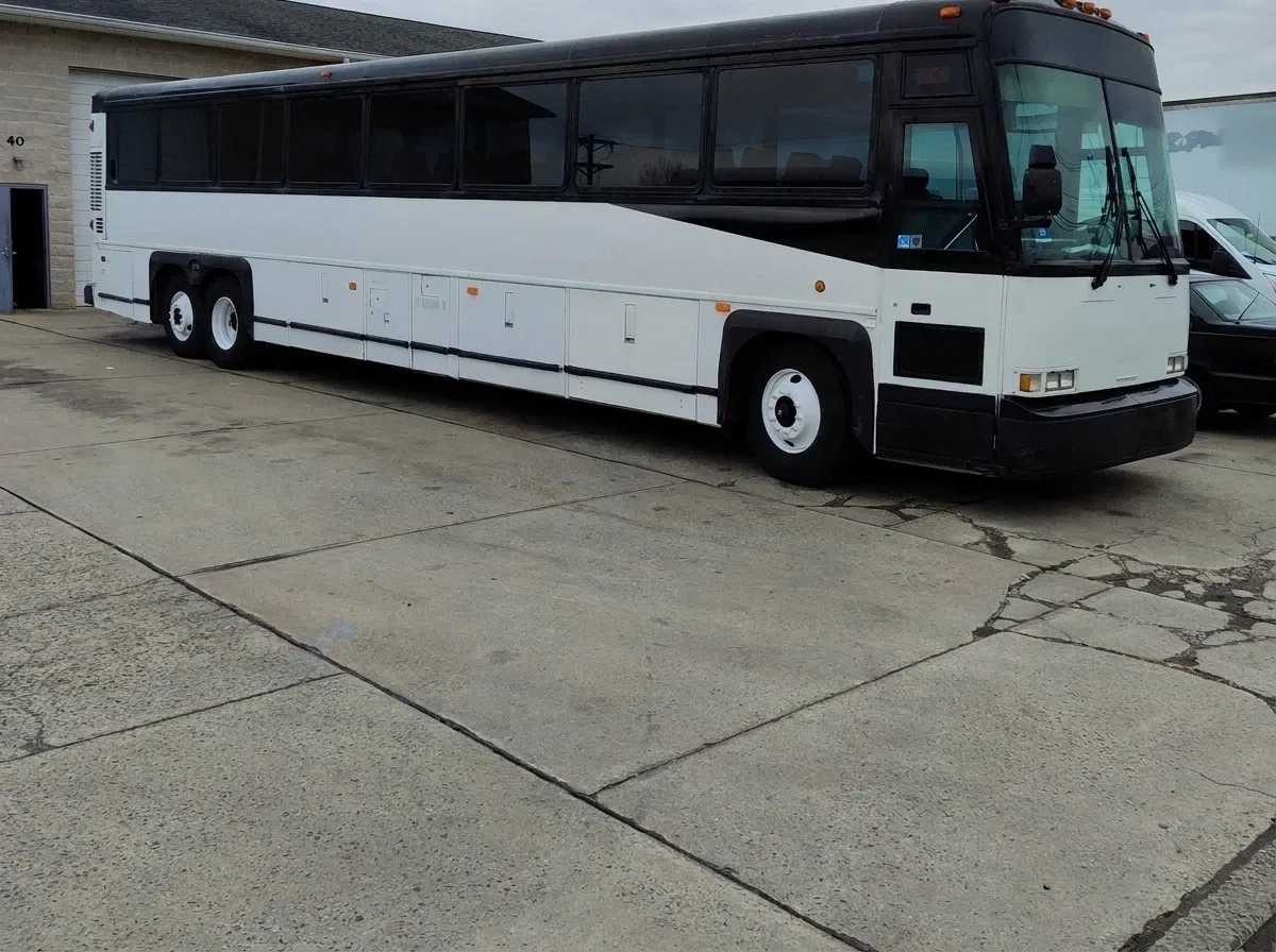 Motorcoach MCI in white, available to rent