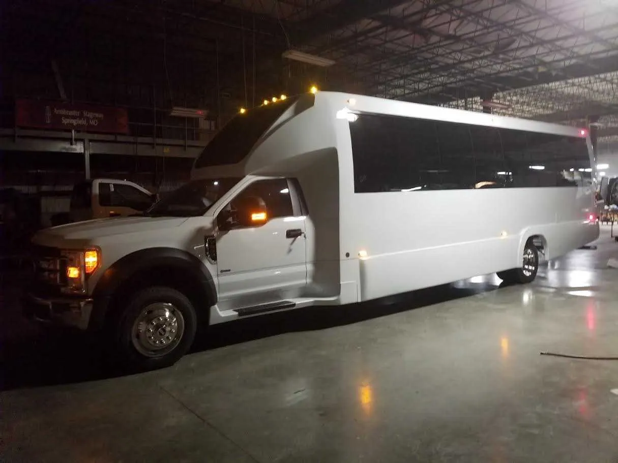 White 28 Passenger Party Bus with tinted windows for party bus rental