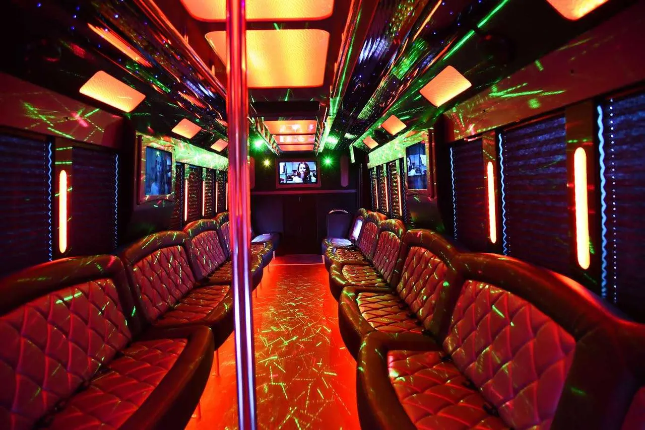 50 Passenger Party Bus 50 Passenger Party Bus interior with perimeter lounge seating, window shades and LED accent lighting for party bus rental