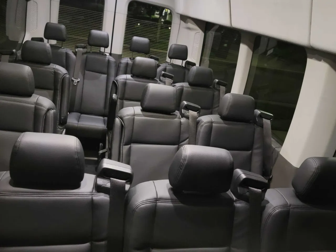 14 Passenger Sprinter in black, available to rent