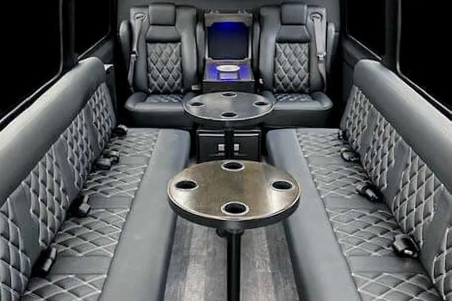 12 Passenger Sprinter Van 12 Passenger Sprinter Van interior with perimeter lounge seating, captain's chairs and passenger tables for party bus rental