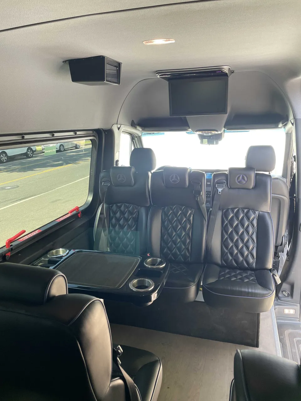 Sprinter Van interior with captain's chairs, passenger tables and cup holders, photo 3 for minibus rental