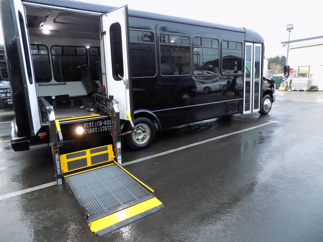 Black VIP Executive ADA Mini Coach with Wheelchair Lift exterior with wheelchair lift for minibus rental