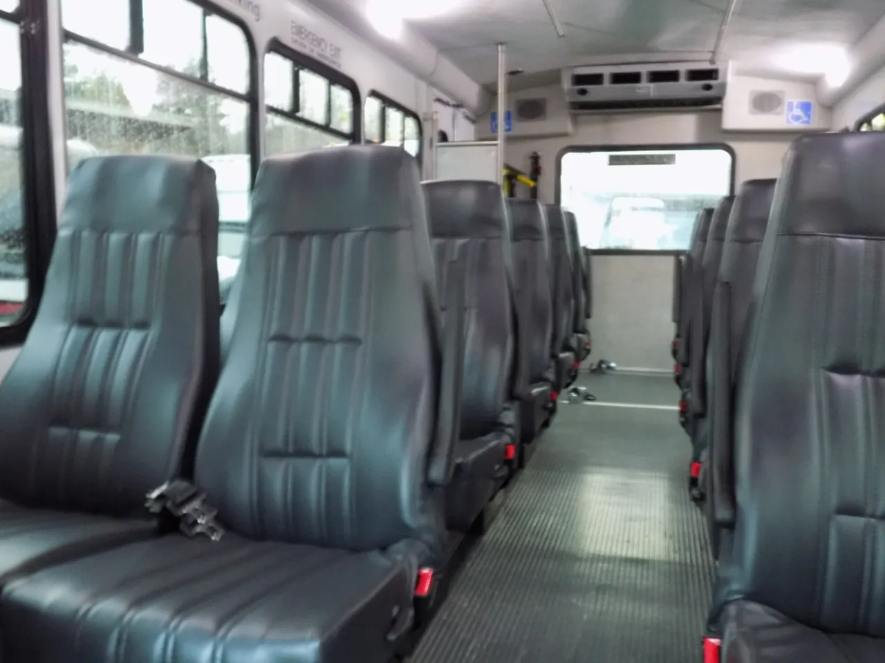 VIP Executive ADA Mini Coach with Wheelchair Lift interior with passenger seat belts for minibus rental