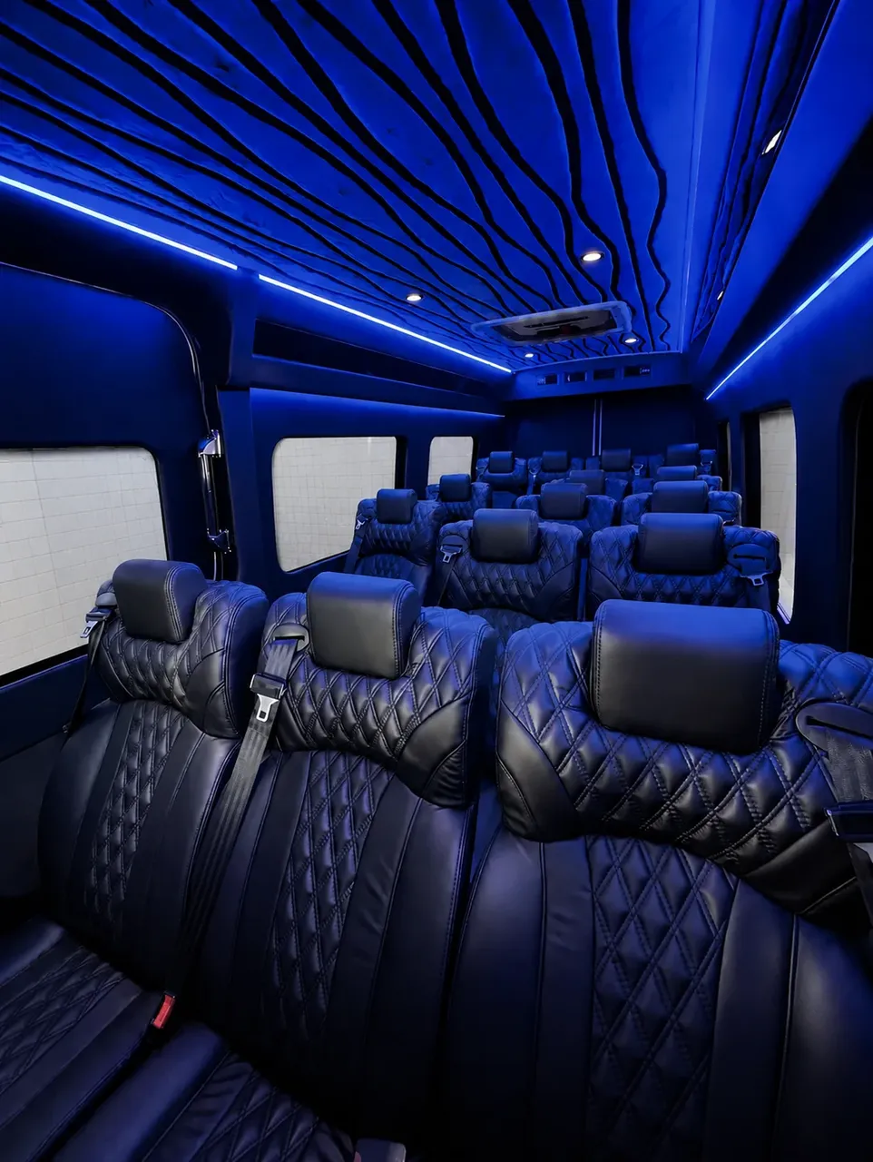 White Luxury Sprinter Shuttle Van interior with window shades, LED accent lighting and LED ceiling lighting for minibus rental